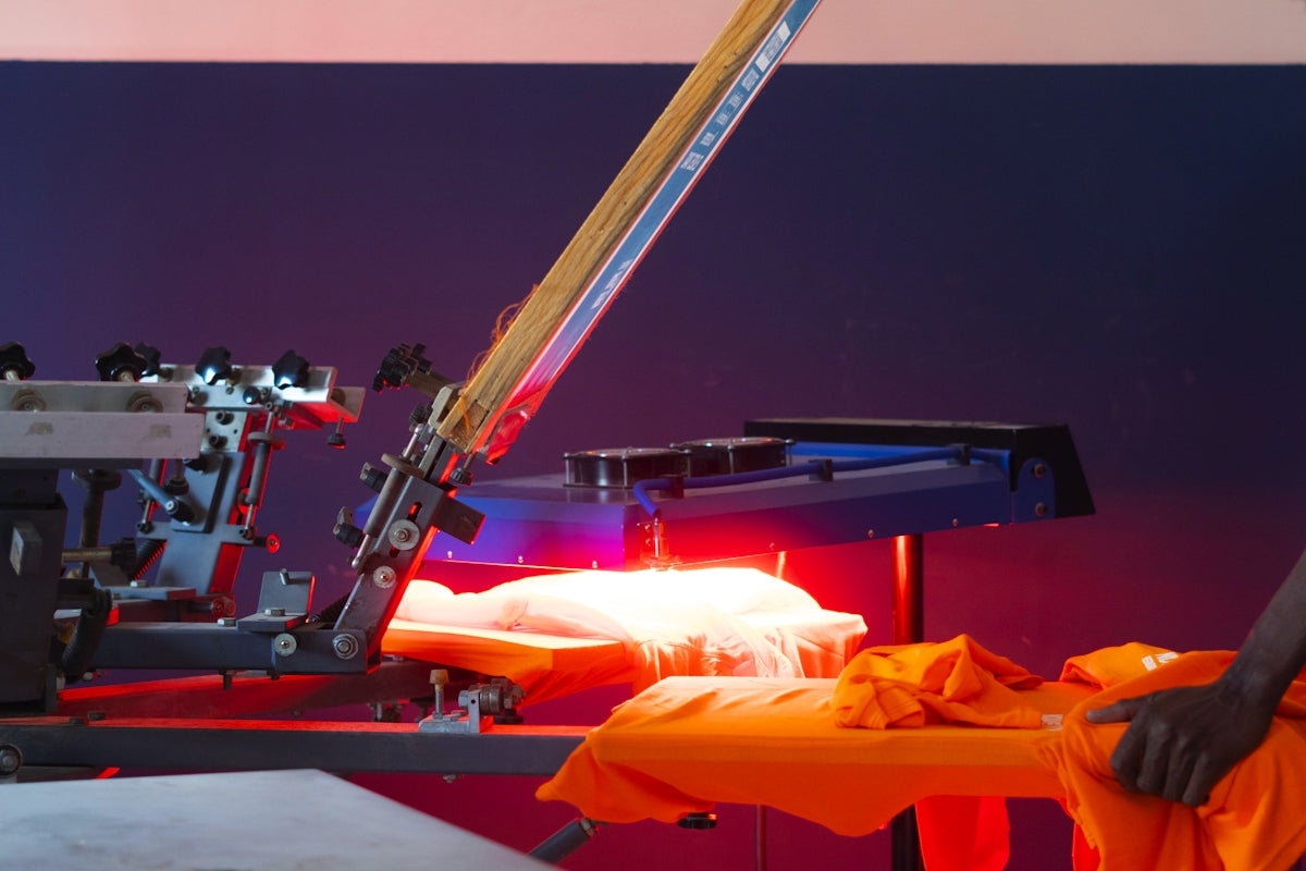 a man standing next to a machine making something