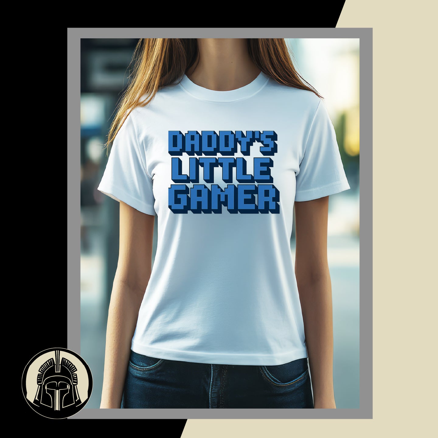 White t-shirt with 'Daddy's Little Gamer' text worn by a person, with a blurred background.