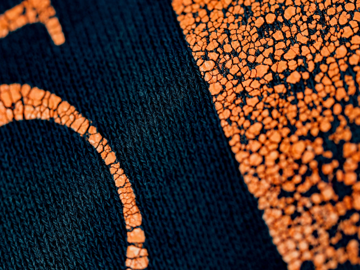 black textile on brown and black marble table
