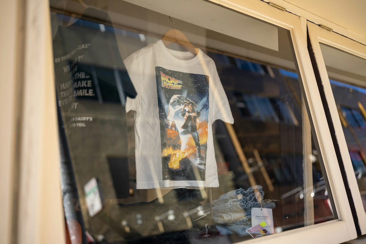 a t - shirt is hanging in a window