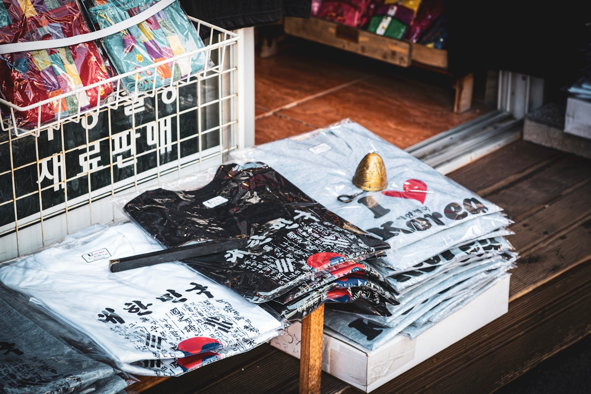 A pile of shirts sitting on top of a wooden floor