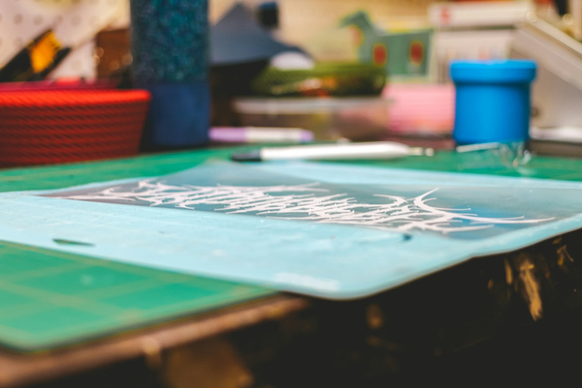 Close-up of a cutting mat with various crafting supplies