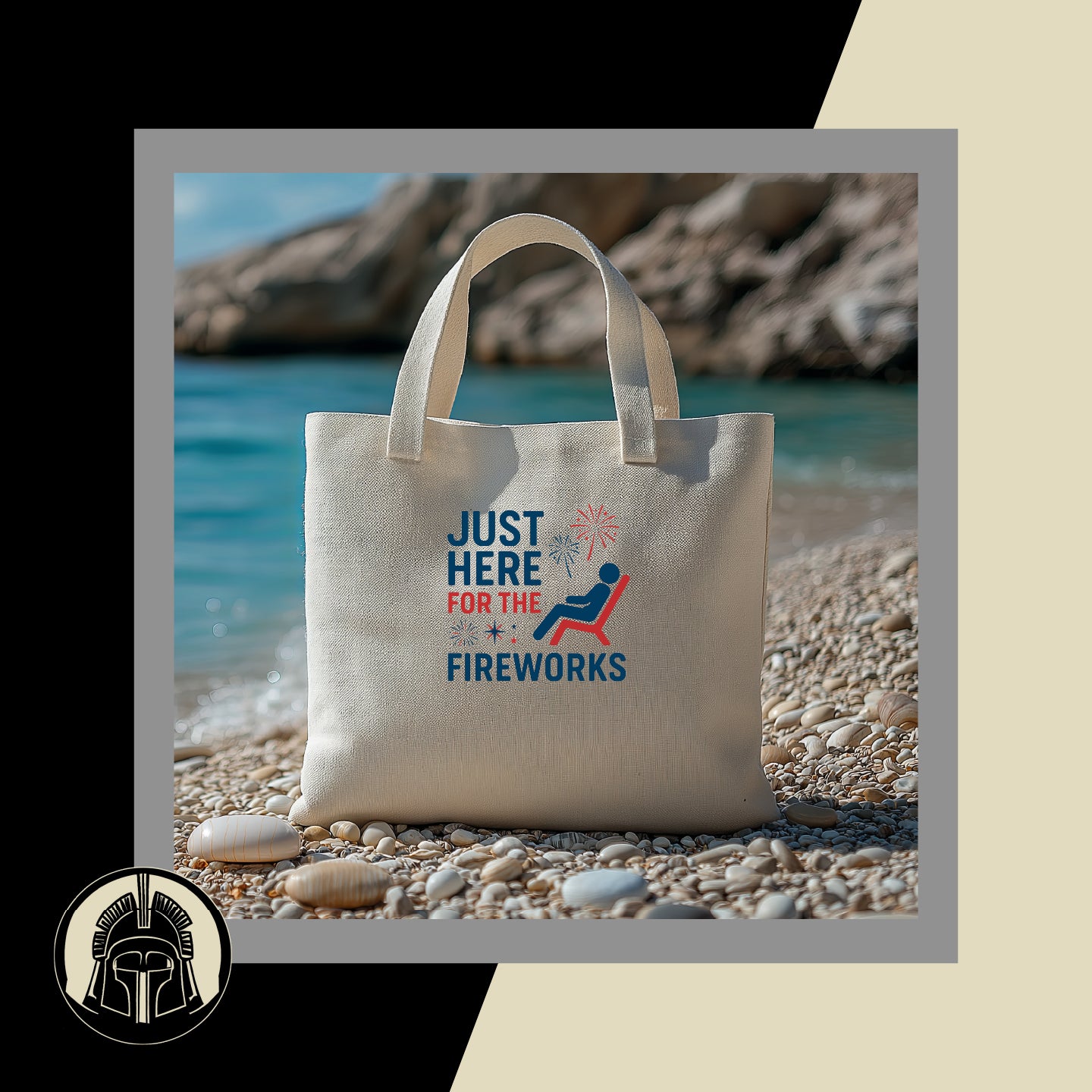 Beige tote bag with 'Just Here for the Fireworks' design on a pebbly beach.